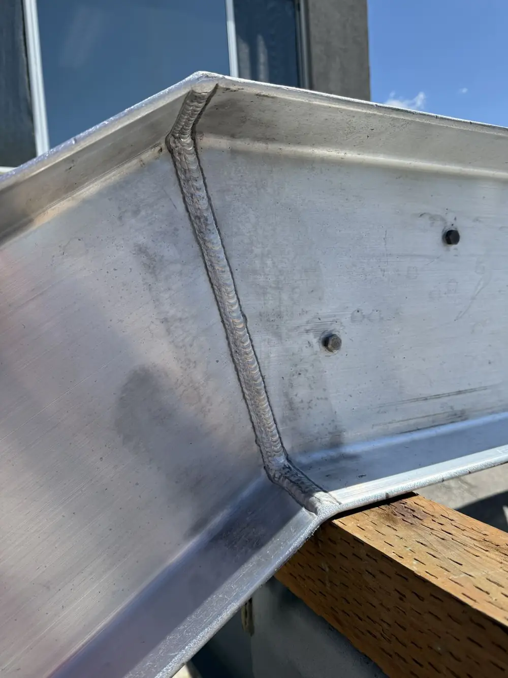Close view of a welded aluminum stair stringer before finishing