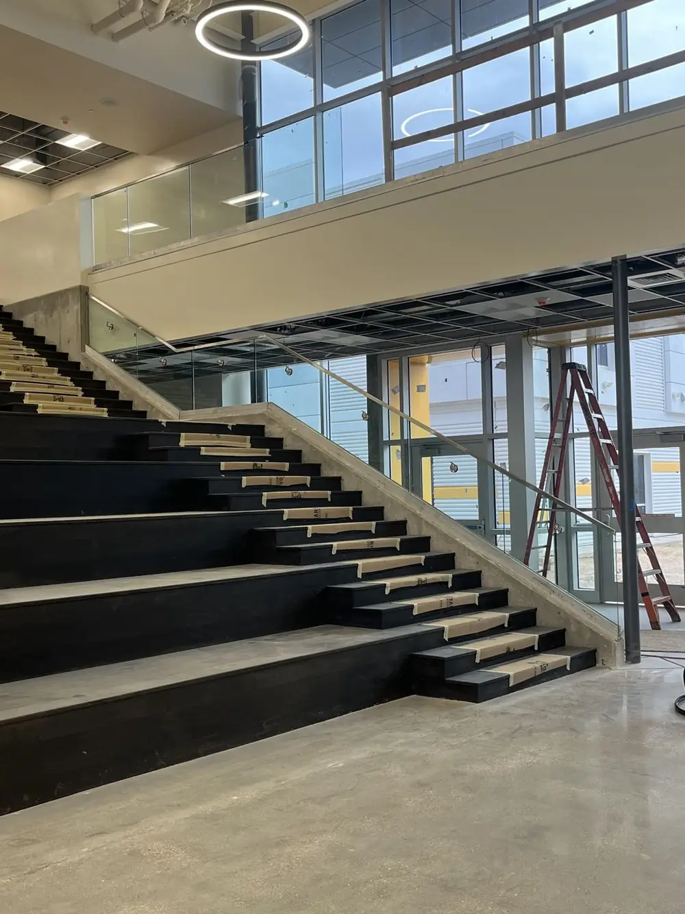 The main stair under construction, bare treads and open structure before rail or finishes