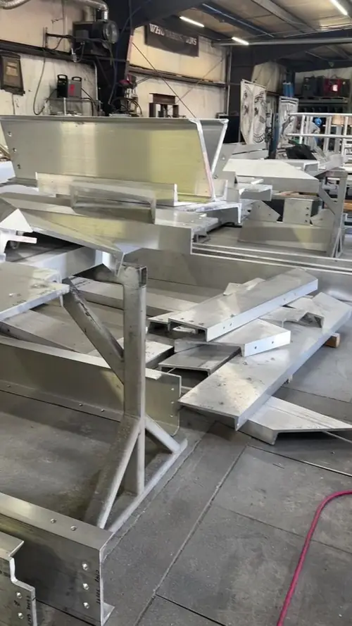 Finished aluminum assemblies staged on the shop floor
