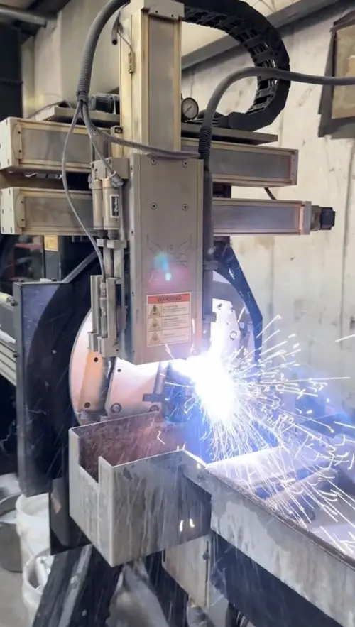 Sparks from a machine cutting steel plate in the shop
