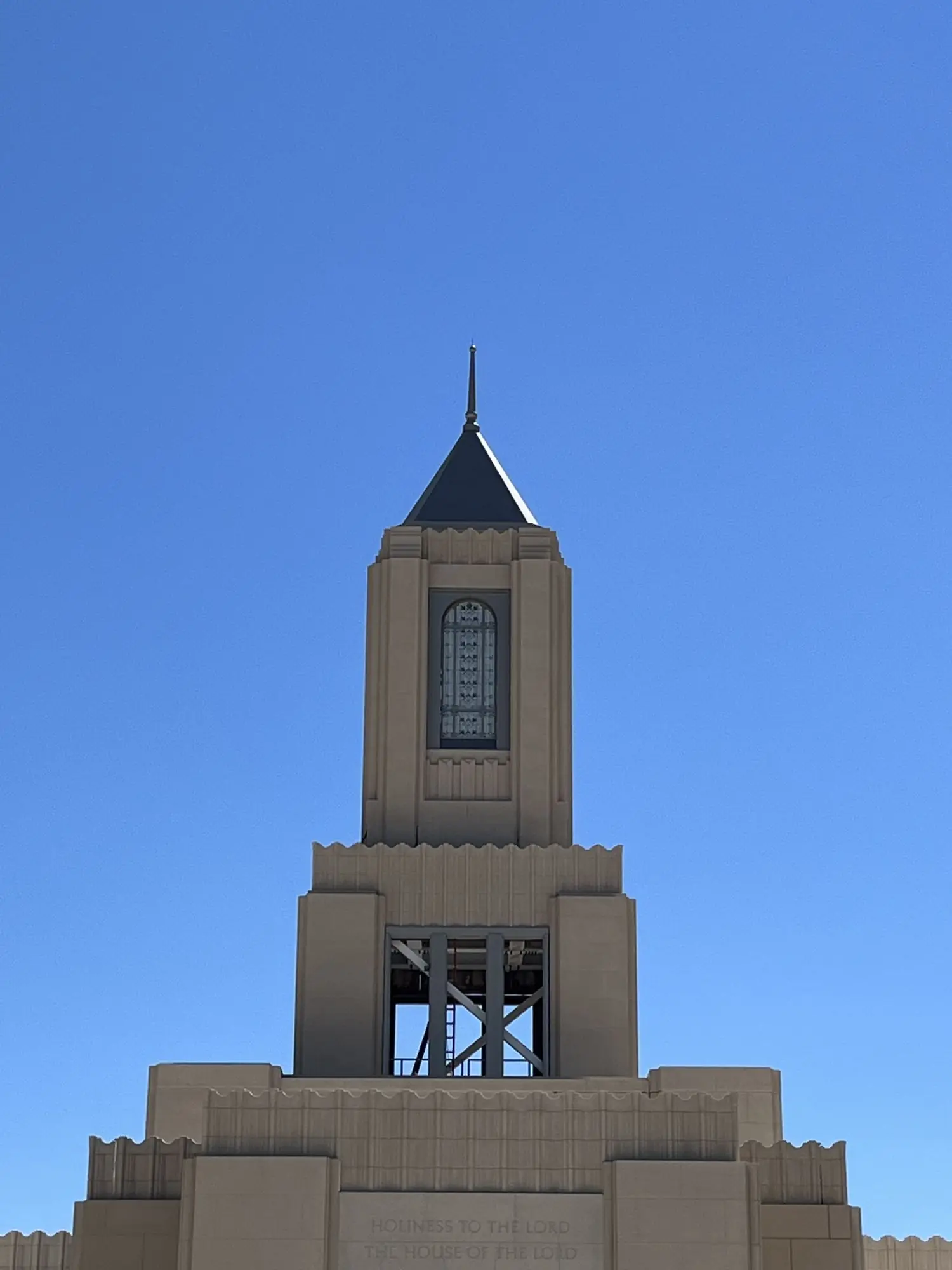The finished temple tower at Casper, the arched decorative window frame set in cast stone against a clear sky