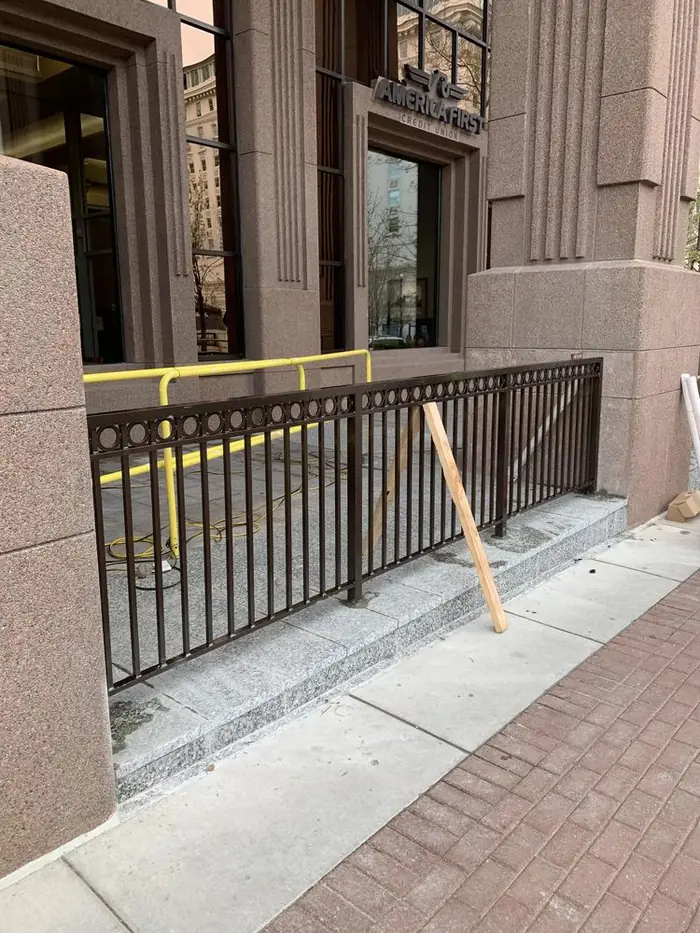 Powdercoated aluminum ornamental guardrail installed outside at City Creek along a granite base