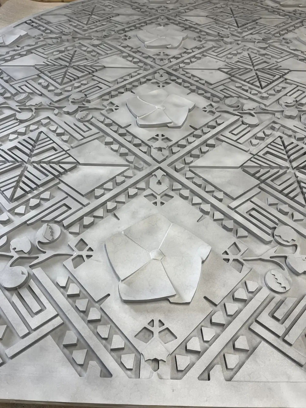 Close detail of the finished relief pattern, the machined faces smooth and even under the coating