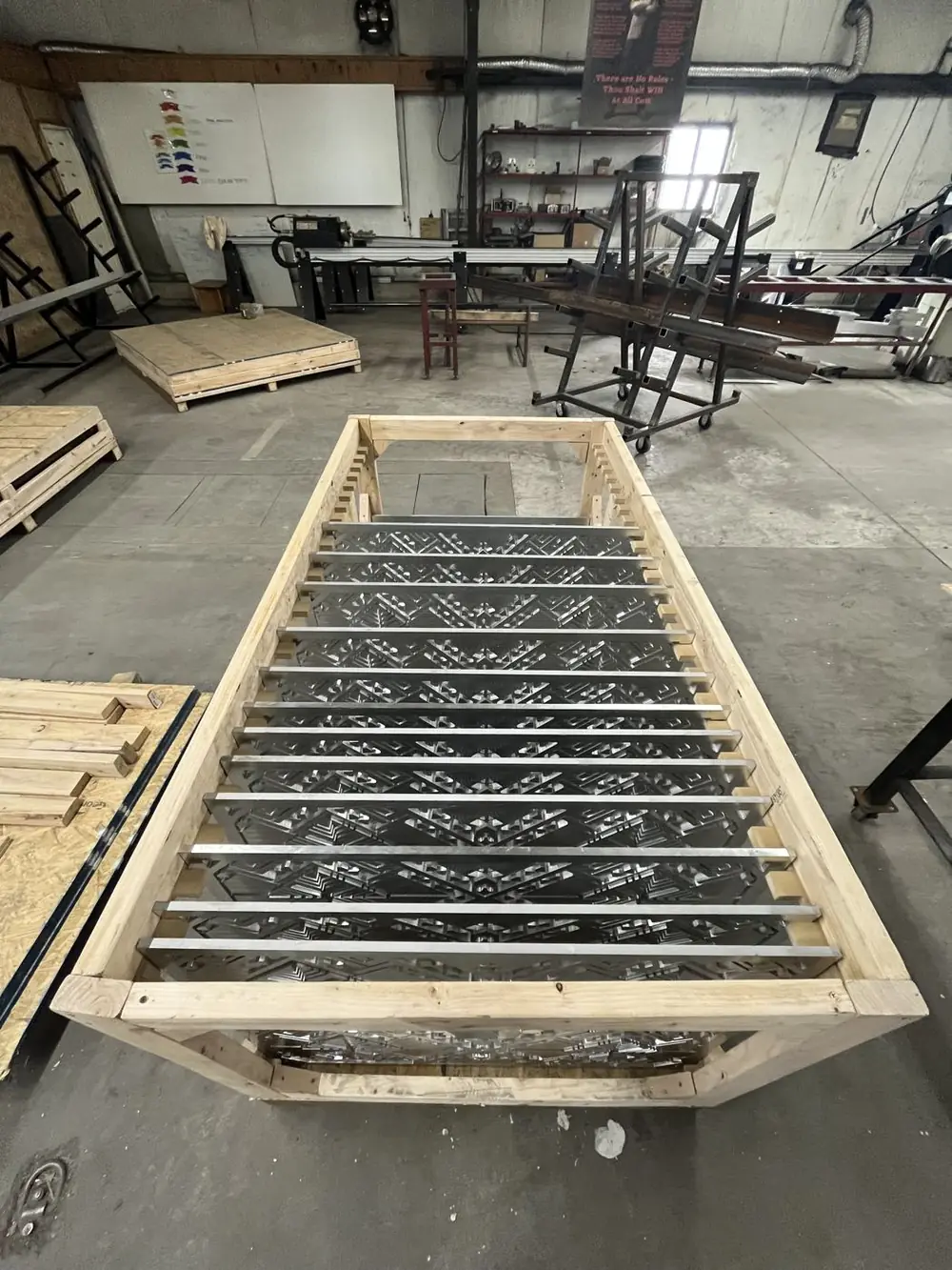 Finished panels stacked and separated in a shipping crate in the shop