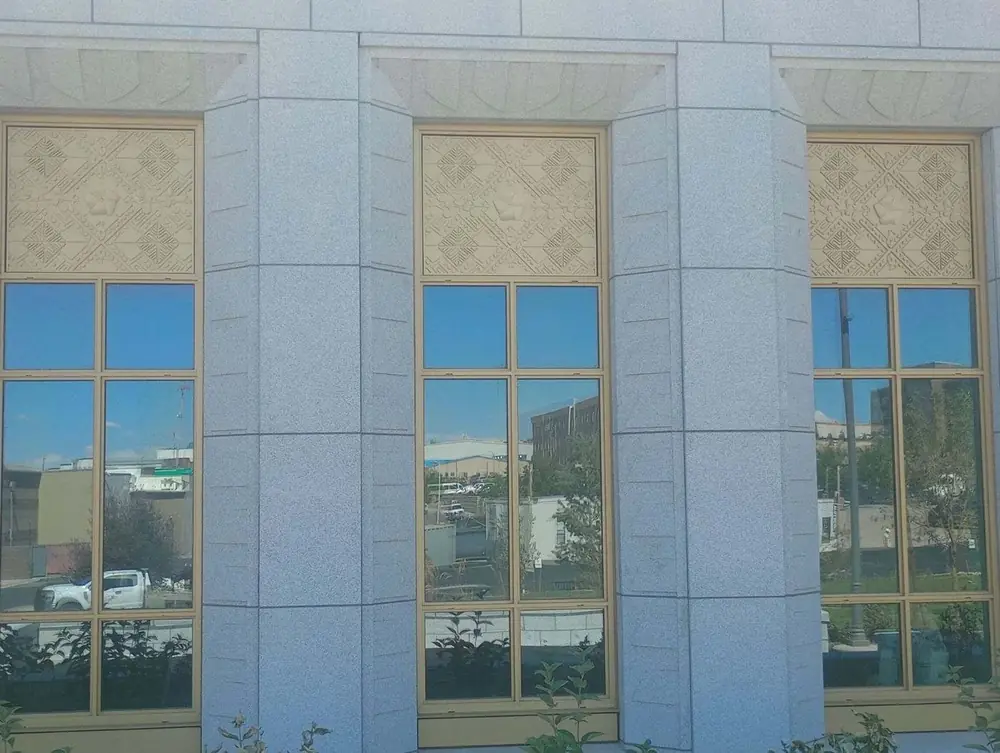 Three finished temple windows, each with a machined relief panel at the head and a plain panel at the bottom