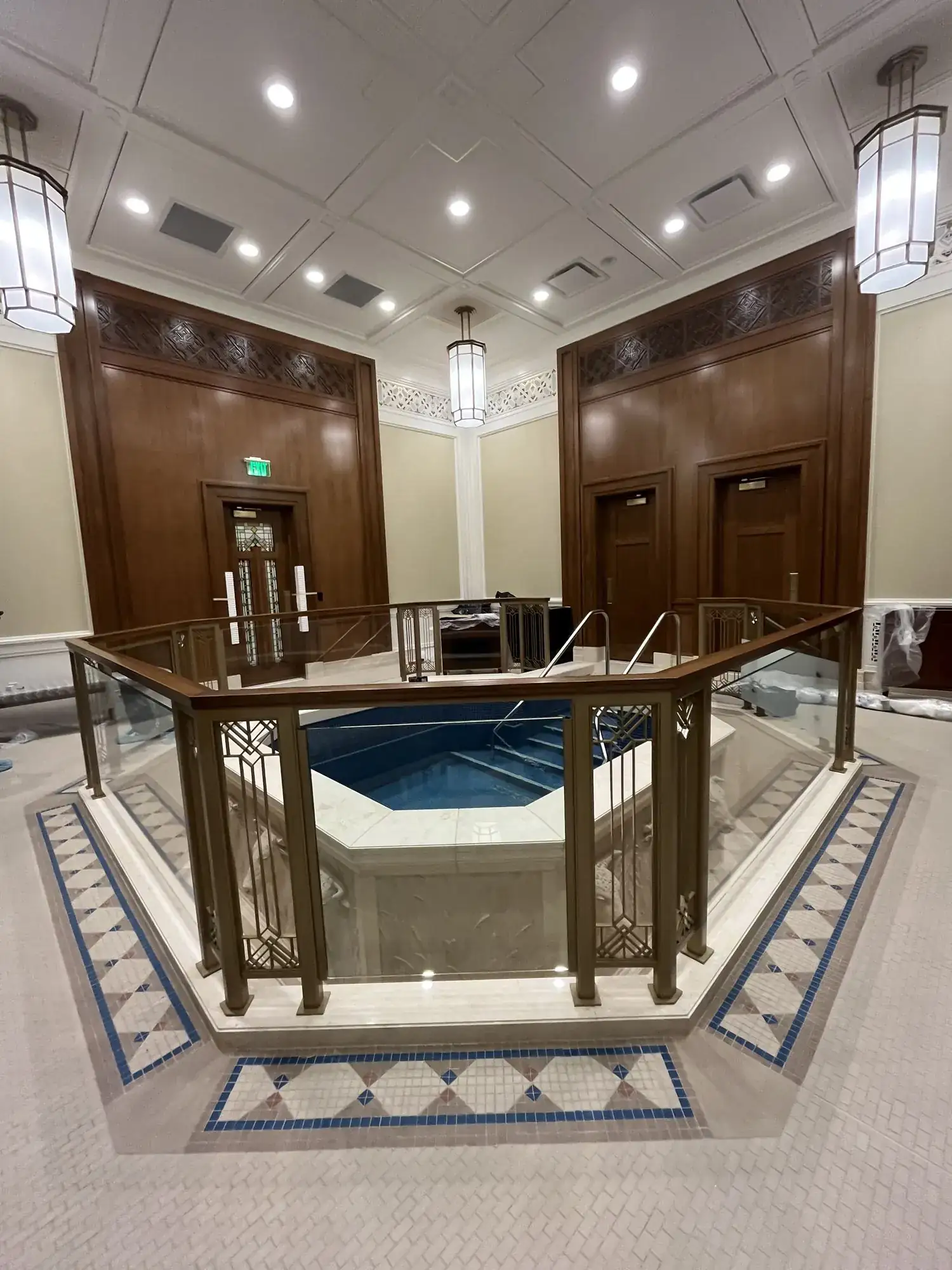 The finished baptistry railing at the Helena Montana Temple, painted aluminum with decorative infill panels and glass
