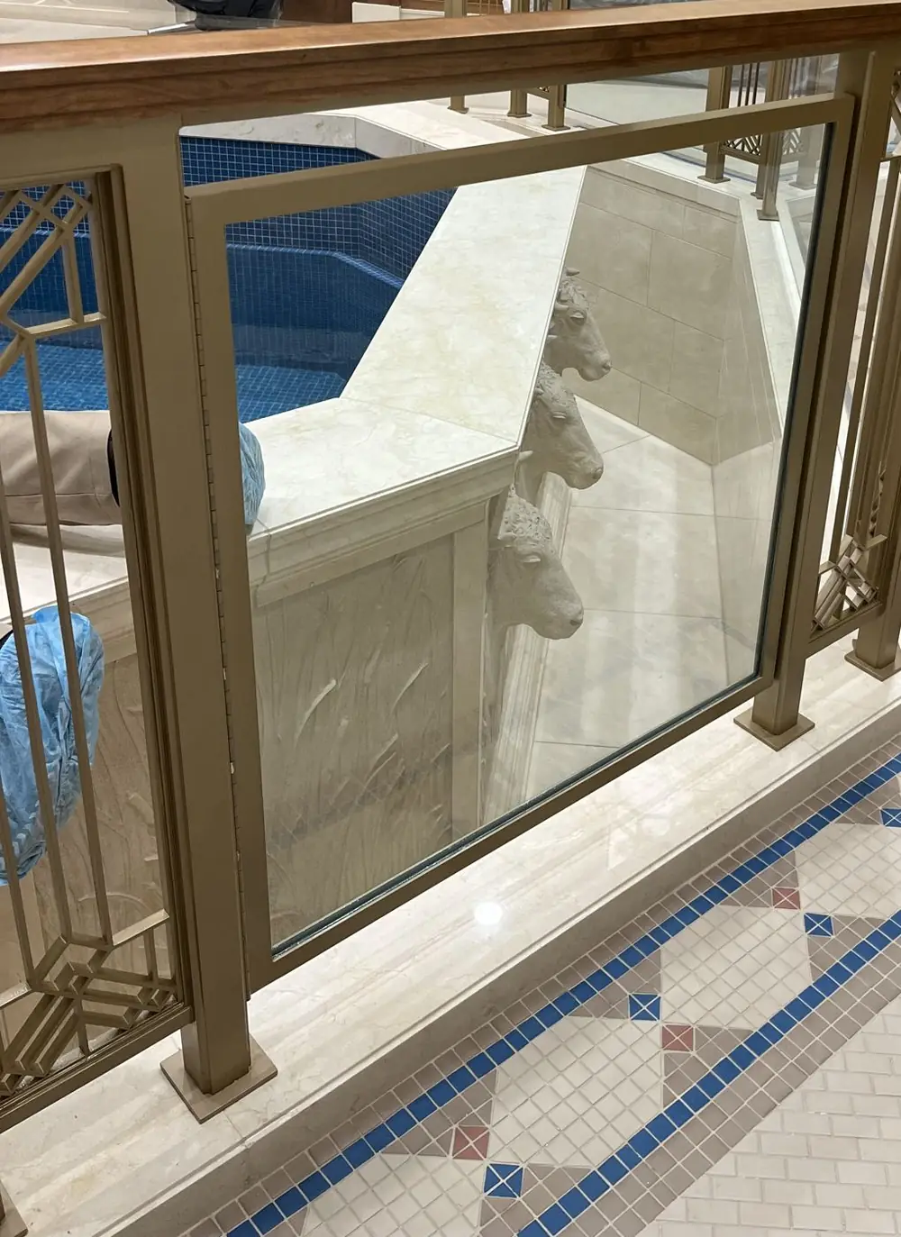 Detail of the baptistry railing — painted aluminum posts, decorative infill panel and glass
