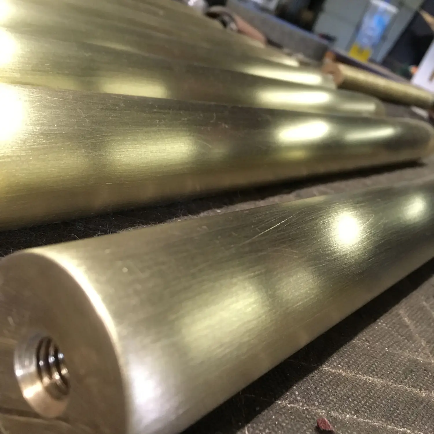 Close view of a brushed architectural bronze cap rail catching raking light