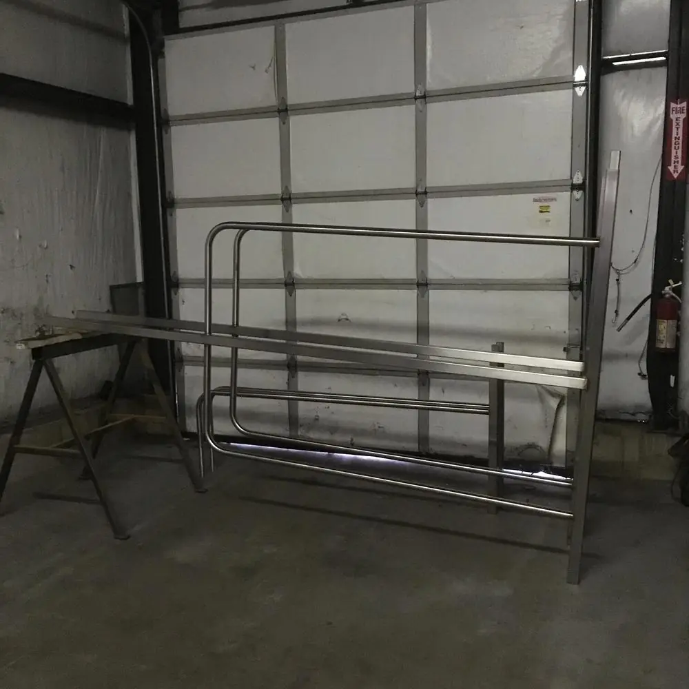 Stainless rail assembly set up on sawhorses in the Arnold Quality shop during fabrication