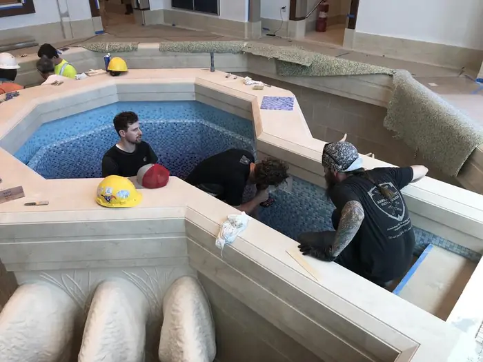 Crew installing the baptistry rail at the font during construction