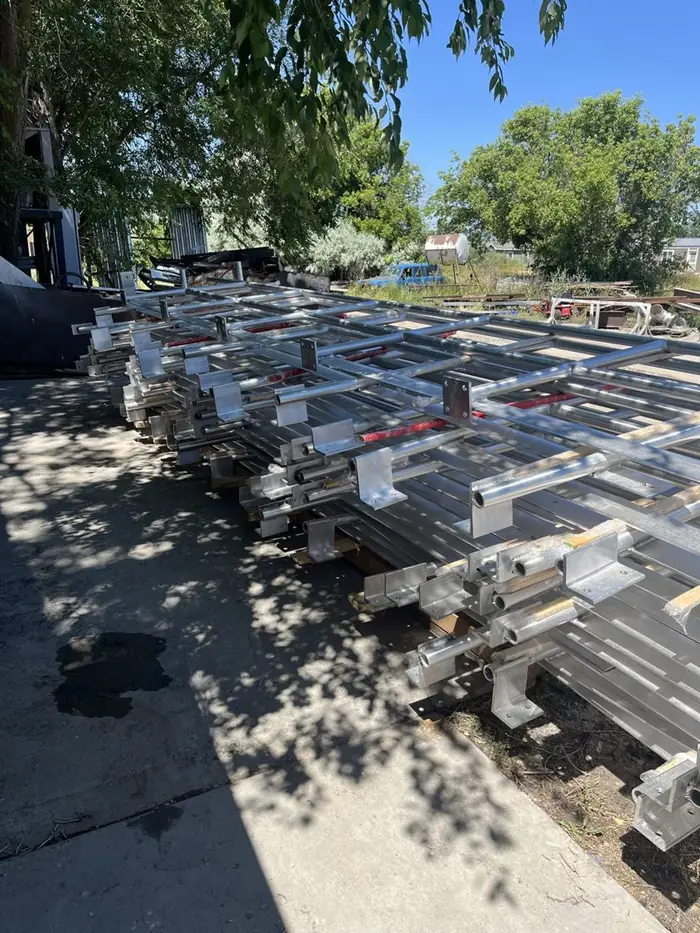 Rows of finished aluminum rail assemblies crated and staged for shipment
