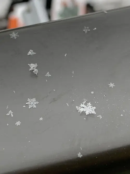 Snowflakes resting on the powdercoated rail surface during installation