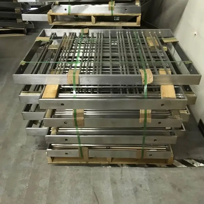Fabricated stainless rail panels bundled and banded on pallets in the shop, ready to ship