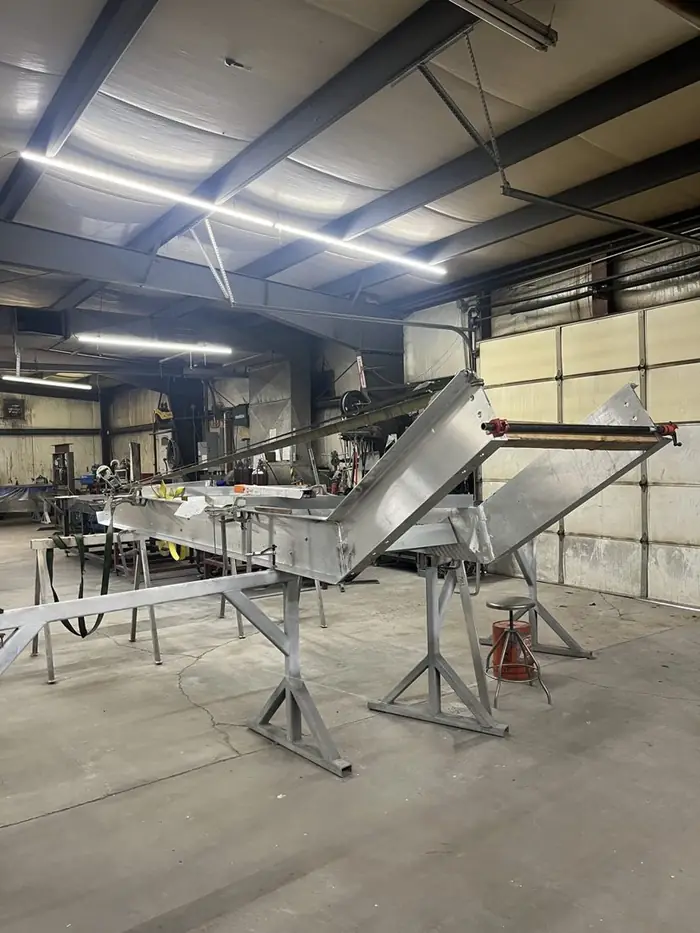 Welded aluminum stair stringer assembly set up on stands in the Arnold Quality shop before finishing
