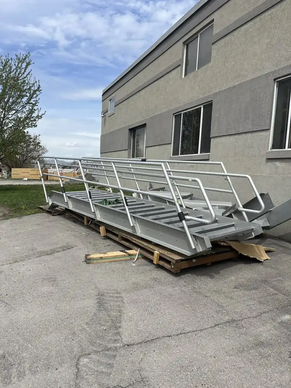 Completed anodized aluminum stair with handrails crated on pallets outside the Logan shop, ready for shipment to Oregon